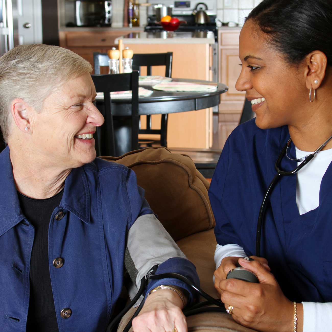 Home health nurse taking a patient's blood pressure.